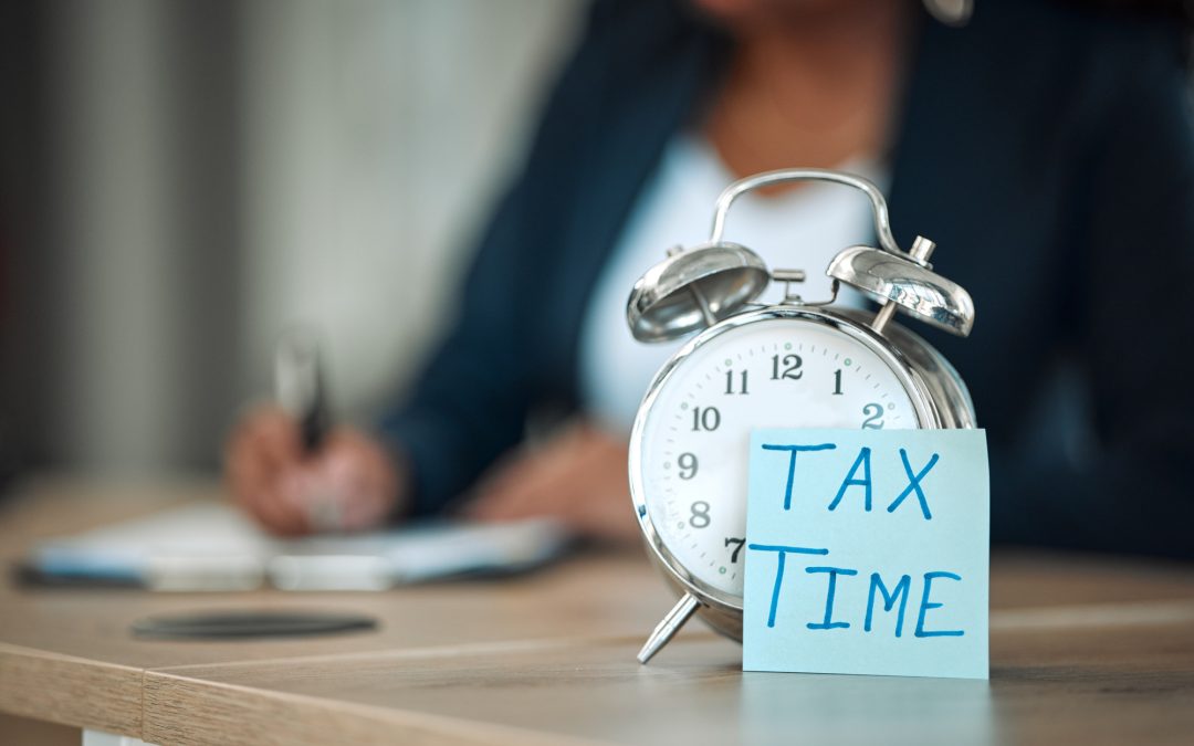 Alarm clock with note saying "Tax Time"